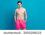 Photo of young handsome man happy positive smile confident cool swimwear isolated over blue color background