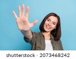 Small photo of Photo of positive cheerful lady show fifth arms fingers math concept wear khaki clothes isolated over blue color background