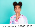Small photo of Photo of silent model stylish young african american girl hold finger lisp sleepwear isolated on teal color background