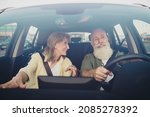 Small photo of Photo of cheerful mature couple conversation ride rant car steering-wheel careful weekend vacation outdoors