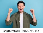 Photo of shocked ecstatic guy win luck lottery raise hands up shout yea isolated on blue color background