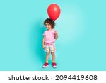 Full length body size view of attractive cheerful girl holding air ball isolated over bright teal turquoise color background