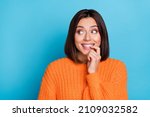 Small photo of Portrait of attractive curious cheerful girl looking aside choosing copy space guess isolated over bright blue color background