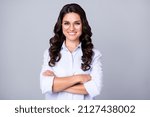 Small photo of Photo of positive candid self-assured lady crossed hands shiny smile wear specs blue shirt isolated grey color background