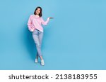 Small photo of Full size photo of optimistic millennial lady stand hold promo wear shirt jeans shoes isolated on blue background