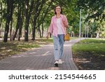 Small photo of Photo of pretty adorable lady pensioner wear pink shirt walking smiling outdoors countryside garden