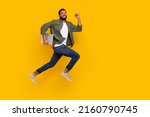 Small photo of Full length photo of cute funky guy dressed green shirt jumping running modern gadget empty space isolated yellow color background