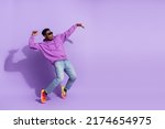 Small photo of Full length profile photo of overjoyed carefree person stand tip toe dancing isolated on purple color background