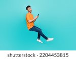 Profile side full body photo of positive guy sit invisible chair blogging device isolated on cyan color background