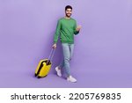 Small photo of Full length photo of young hispanic arabian guy hold gadget tourist use roaming wear trendy green look isolated on violet color background