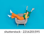 Full length photo of overjoyed carefree person sit chair have fun good mood isolated on blue color background