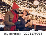 Photo of positive pretty boyfriend girlfriend dressed winter season outfits drinking x-mas beverages outdoors urban city street