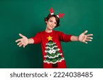 Photo of funky charming lady wear red sweater horns hair band open arms ready hug you isolated green color background