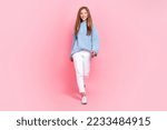 Small photo of Full body size photo of young cute beautiful funny teenager girl wear blue knit autumn sweater walking defile isolated on pink color background