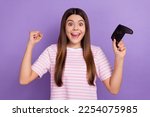 Photo of excited lucky lady wear striped white t-shirt winning playstation game isolated violet color background