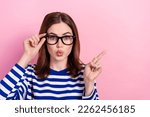 Small photo of Photo of astonished clever lady wear stylish sailor shirt arm demonstrate empty space banner ad isolated on pink color background
