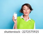 Small photo of Photo of nice funny lady look hand hold fresh milk glass tongue lick lip isolated on blue color background