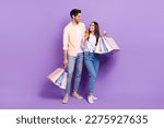 Small photo of Full body portrait of two positive people hold boutique bags use telephone look each other isolated on purple background