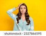 Small photo of Photo of young funny clueless nervous lady wear turquoise cardigan hand head problems hesitate forgot wallet isolated on yellow color background