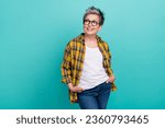 Small photo of Photo of lovely senior lady hands pockets defile posing dressed stylish checkered yellow garment isolated on aquamarine color background
