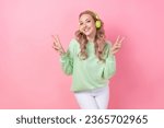 Portrait of woman dancing two hands v sign demonstrate her peace chill listen wireless headphones apple isolated on pink color background