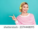 Portrait of young lady wearing striped shirt point finger mockup enjoy headphones itunes student discount isolated on blue color background