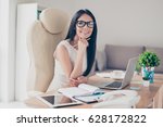 Success conception. Portrait of gorgeous young businesslady in glasses sitting at her workplace in the office