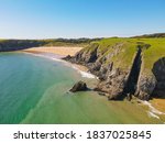 Coastal view of Barafundle Bay Beach, Pembrokeshire, Wales UK. A calm blue and turquoise ocean in a tropic-like setting. 