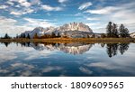 Small photo of Aufnahme des Wilden Kaiser am Speichersee Harschbichl in St. Johann in Tirol. Die absolute Windstille an diesem Tag fuhrte zu der fast makellosen Spiegelung.