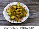 Small photo of Slices of pickled cucumber, pickle, gherkin, usually small or miniature cucumber that has been pickled in a brine, vinegar, or other solution and left to ferment, part of mixed pickles, food appetizer