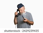 Small photo of An old sailor from the past is talking on the phone. Portrait on a white background. Sailor with a smoking pipe and an old telephone in his hand