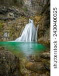 Small photo of Vertical photo of one of the blue pools of the Mundo River waterfall after the February outburst in Albacete, Castilla La Mancha, Spain, on a cloudy morning