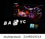 Small photo of Stuttgart, Germany - 03-29-2022: Person holding smartphone with logo of Bored Ape Yacht Club (BAYC, Yuga Labs) on screen in front of website. Focus on phone display. Unmodified photo.