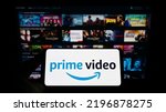 Small photo of Stuttgart, Germany - 07-16-2022: Person holding smartphone with logo of streaming service Amazon Prime Video on screen in front of website. Focus on phone display. Unmodified photo.