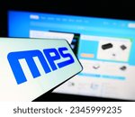 Small photo of Stuttgart, Germany - 08-05-2023: Smartphone with logo of American company Monolithic Power Systems Inc. (MPS) on screen in front of website. Focus on left of phone display. Unmodified photo.