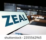 Small photo of Stuttgart, Germany - 08-24-2023: Smartphone with logo of German lottery company ZEAL Network SE on screen in front of business website. Focus on center-left of phone display. Unmodified photo.