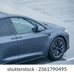 Small photo of Neufchatel-Hardelot, France - Aug 18, 2023: From above, a Tesla Model X electric car, engulfed in a heavy downpour, showcases a multitude of raindrops