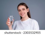 Girl drinking water, isolated on studio background. Young woman enjoy pure fresh mineral water. Thirsty woman hold glass aqua water. Healthy water to refreshment.