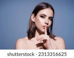 Small photo of Say secret hush be quiet with finger on lips. Shhh gesture isolated on studio background portrait. Girl showing hush. Woman say secret hush be quiet with finger on lips, shhh gesture.
