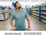 Small photo of Man in shop, market store. Man shopping in supermarket. Sales, shop and shopping. Guy in shop market. Shopping center. Man shopper with shopping cart. .