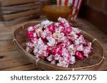 selective focus on popcorn dyed red in a bamboo basket, soft focus