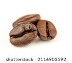 Coffee beans are Robusta. On a white background. Robusta is praised for its high caffeine content, low sugar content and low acidity. Selective focus.