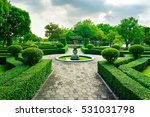 Small photo of Sleepiness fountain in middle of crushed rock road are luxury garden in Bangkok, Thailand. This line of crushed rock road go straight to fountain concept, forest and blue sky in a background.