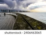Small photo of The pier of Blankenberge with the sea and different weather conditions. Belgium coast toerism. Belgium coast, north sea. Kid riding bicycle, bike, toerism belgium. Postcard beaches, coast belgium.
