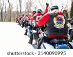 Small photo of O'FALLON, MISSOURI - March 27, 2022: Members of the AMVETS Riders Post 106, a veteran motorcycle club, prepare to ride off after laying a wreath in remembrance of fallen Vietnam veterans.