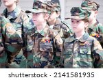 Small photo of O'FALLON, MISSOURI - March 28, 2022: Members of the Young Marines, a youth leadership and service program for children, stand in formation wearing camouflaged military uniforms.