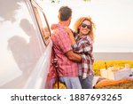 Adult happy couple enjoy love and relationship during outdoor leisure activity together - concept of travel with van and summer holiday vacation for cheerful people - beautiful woman man husband hug