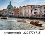 Small photo of Venezia, Italy 19-07-2022. Viability of the city of Venice. Example of maritime traffic in the Venetian city in front of the Church of San Simeone.