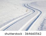 Car tire track on a empty winter road