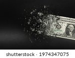 Small photo of Inflation, dollar hyperinflation with black background. One dollar bill is sprayed in the hand of a man on a black background. The concept of decreasing purchasing power, inflation.